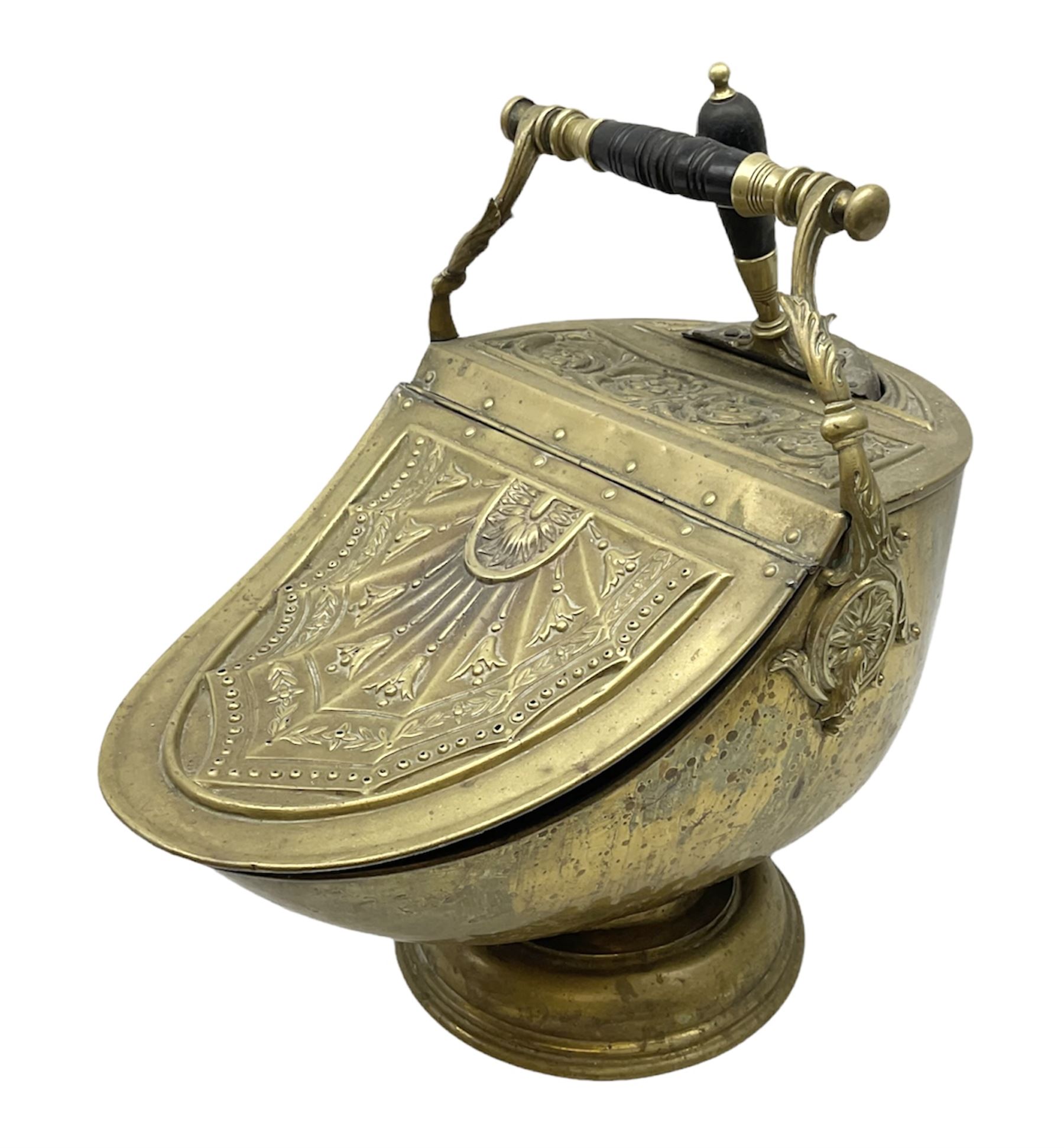 Victorian brass helmet shaped coal scuttle with embossed decoration and turned wooden handle and shovel, H49cm