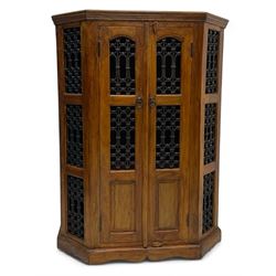 Hardwood and wrought iron cabinet, enclosed by two doors, on plinth base 