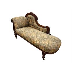 Victorian Aesthetic Movement mahogany framed chaise longue, shaped carved back over acanthus scrolled arm terminal, upholstered in floral patterned tapestry fabric with sprung seat, on turned and fluted supports with castors