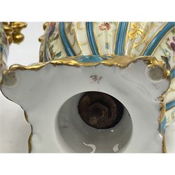 Pair of late 19th/early 20th century Sevres style vases and covers, of baluster form with gilt scroll handles and domed covers, the wrythen fluted bodies decorated with alternating bands of painted fruit and flowers and gilt vines, upon a white and celeste blue ground, with printed and impressed marks beneath, H22.5cm 