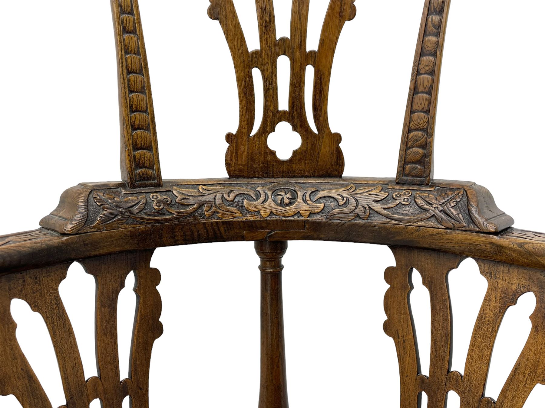 Elm 'Windsor' splat back corner armchair, shaped cresting rail carved with leaves over shaped and pierced splat, the curved arms carved with foliage and scrolled terminals, turned upper supports and a further two splats, panelled seat within foliate carved seat rails, on square rear supports with front shell carved cabriole support, united by plain x-frame stretchers