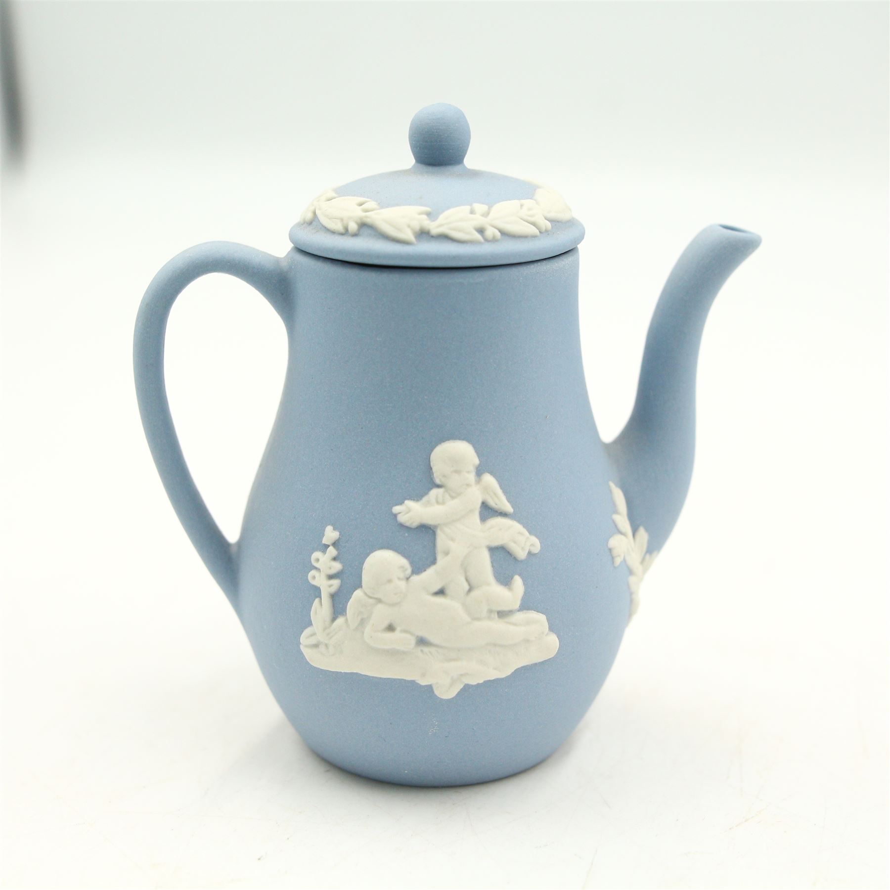 Wedgwood Jasperware miniature tea set for one, on a matched tray, oval scent bottle with silver cover, four caddy spoons, miniature bell, seven thimbles, together with a cased pair of portrait medallions of Josiah Wedgwood FRS and Thomas Bentley 