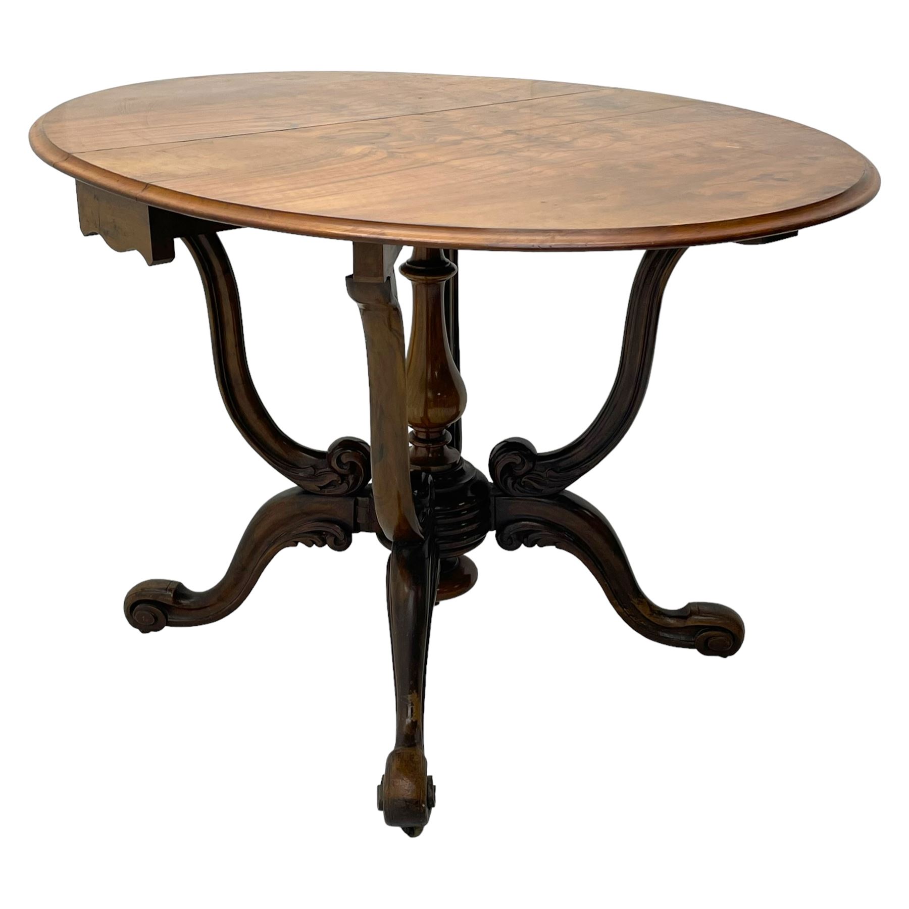 Unusual Victorian figured walnut drop-leaf Sutherland table, moulded drop-leaf oval top, central turned baluster column with quadruple moulded S-scroll supports carved with acanthus leaves, four out-splayed supports with scroll carved terminals, double gate-leg action base, on castors