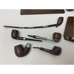 Collection of smoking pipes including Meerschaum pipe, carved as a female head, Briars and clay examples, etc and four pipe racks/stands