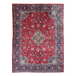 Kashan crimson ground carpet, overall floral design, the central medallion surrounded by t...