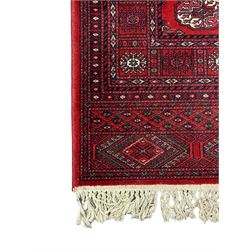 Persian Bokhara crimson ground runner rug, the field with a series of repeating ivory octagonal medallions, main border with repeating flower head pattern and diamonds within multiple guard stripes