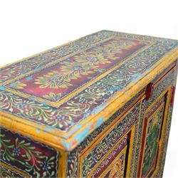 Indian painted hardwood storage cupboard, with painted floral decoration, enclosed by two panelled doors, the interior fitted with one shelf 