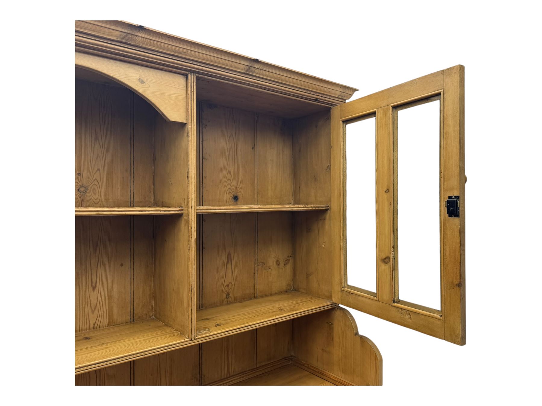 Large pine dresser, raised display cabinets over three drawers and three panelled cupboards, on plinth base