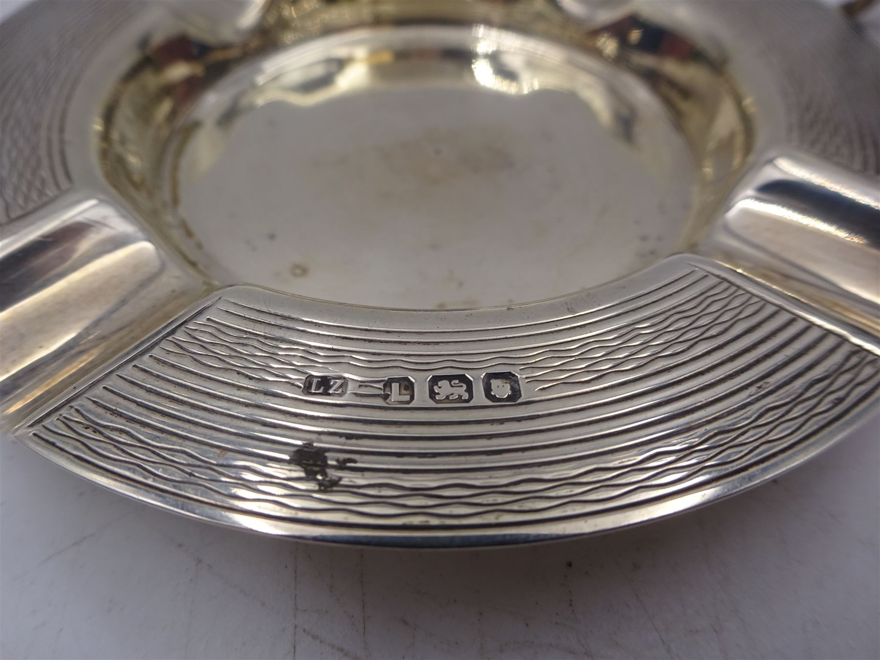 1930s silver five bar toast rack, with loop handle, hallmarked Adie Brothers Ltd, Birmingham 1934, together with a 1940s silver ashtray with engine turned decoration, hallmarked, toast rack H9cm