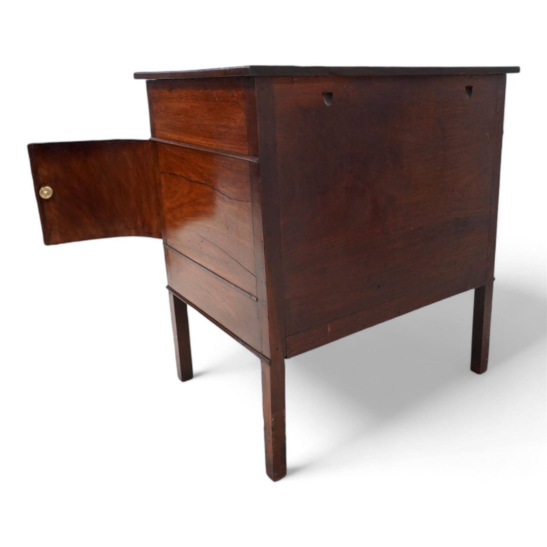 George III mahogany concave side cabinet, rectangular protruding top over a single drawer, the recessed concave body fitted with a double cupboard and single drawer, lower moulded edge on square supports