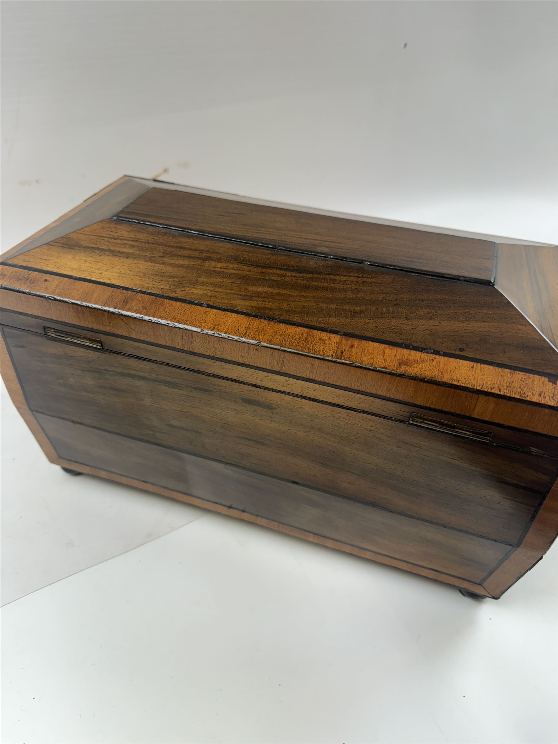 Georgian sarcophogus shaped tea caddy, with inlaid panels and twin lion mask handles, with mahogany compartmentalised interior, upon four bun feet, H22cm