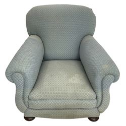 20th century traditional shape armchair, curved back and rolled arms, upholstered in light blue patterned fabric, on turned front feet