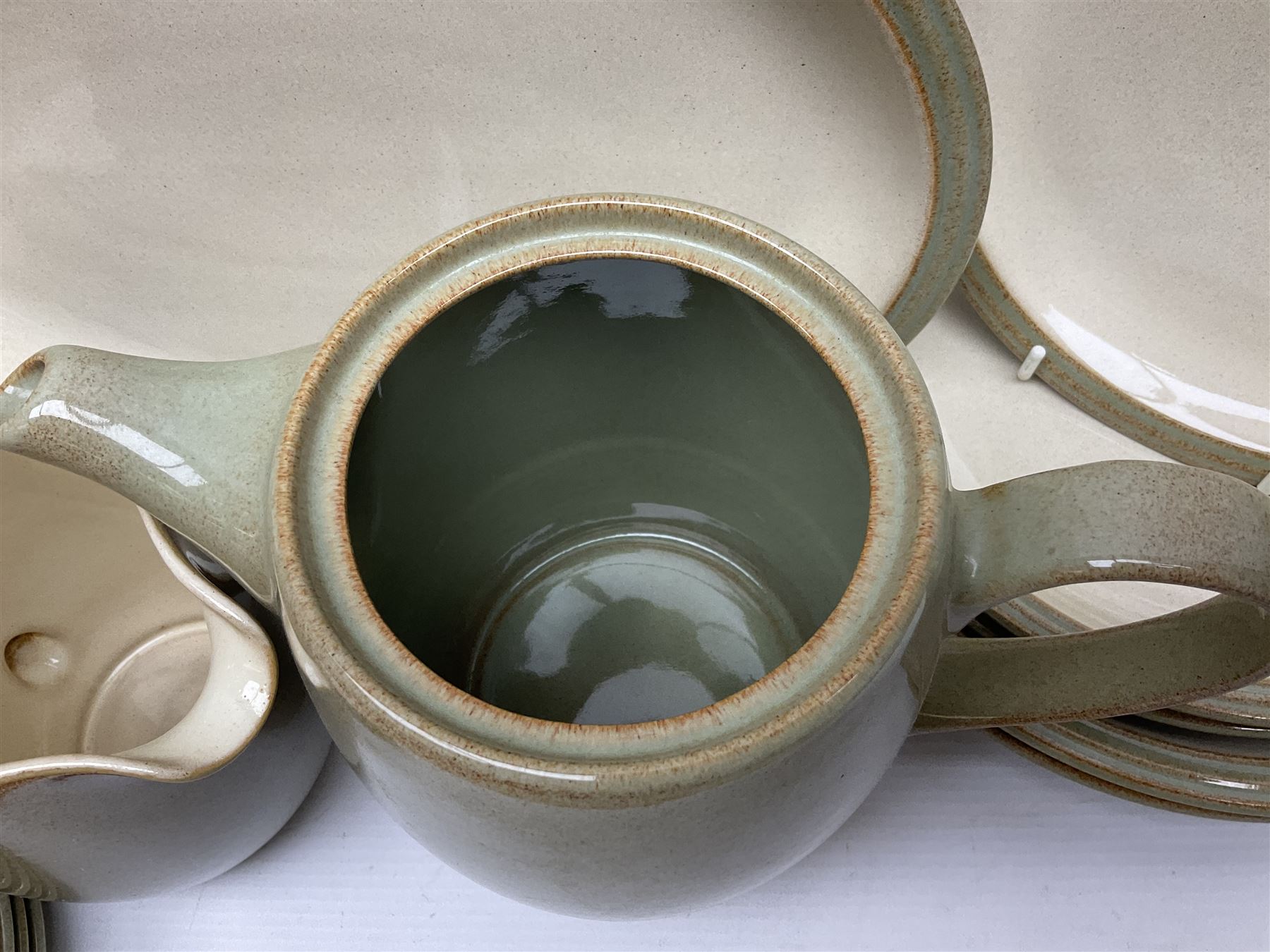 Denby tea and dinner wares, including bowls, jugs, tureens, side plates, dinner plates, serving dishes, cups and saucers, coffee pot, etc, all decorated with a green and brown mottled glaze, with printed marks beneath, in two boxes 