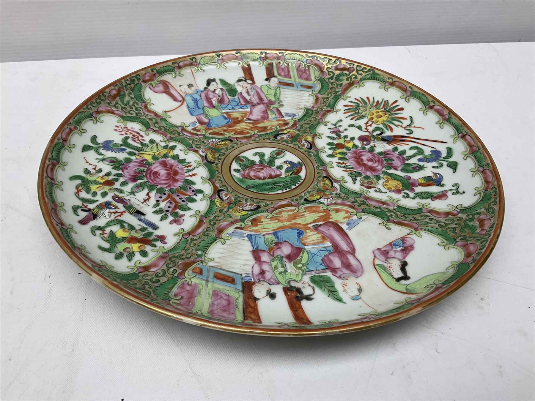 Chinese Famille Rose plate, decorated in polychrome enamels with four figural panels, D24cm.