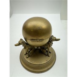 19th century brass desk inkwell, the central spherical chamber supported by three seated hounds, upon a circular base, H10.5cm, together with a further brass example modelled as a dog and dog kennel with hinged roof opening to reveal an inkwell, upon oval base, and white marble plinth, overall H7.5cm W16cm 