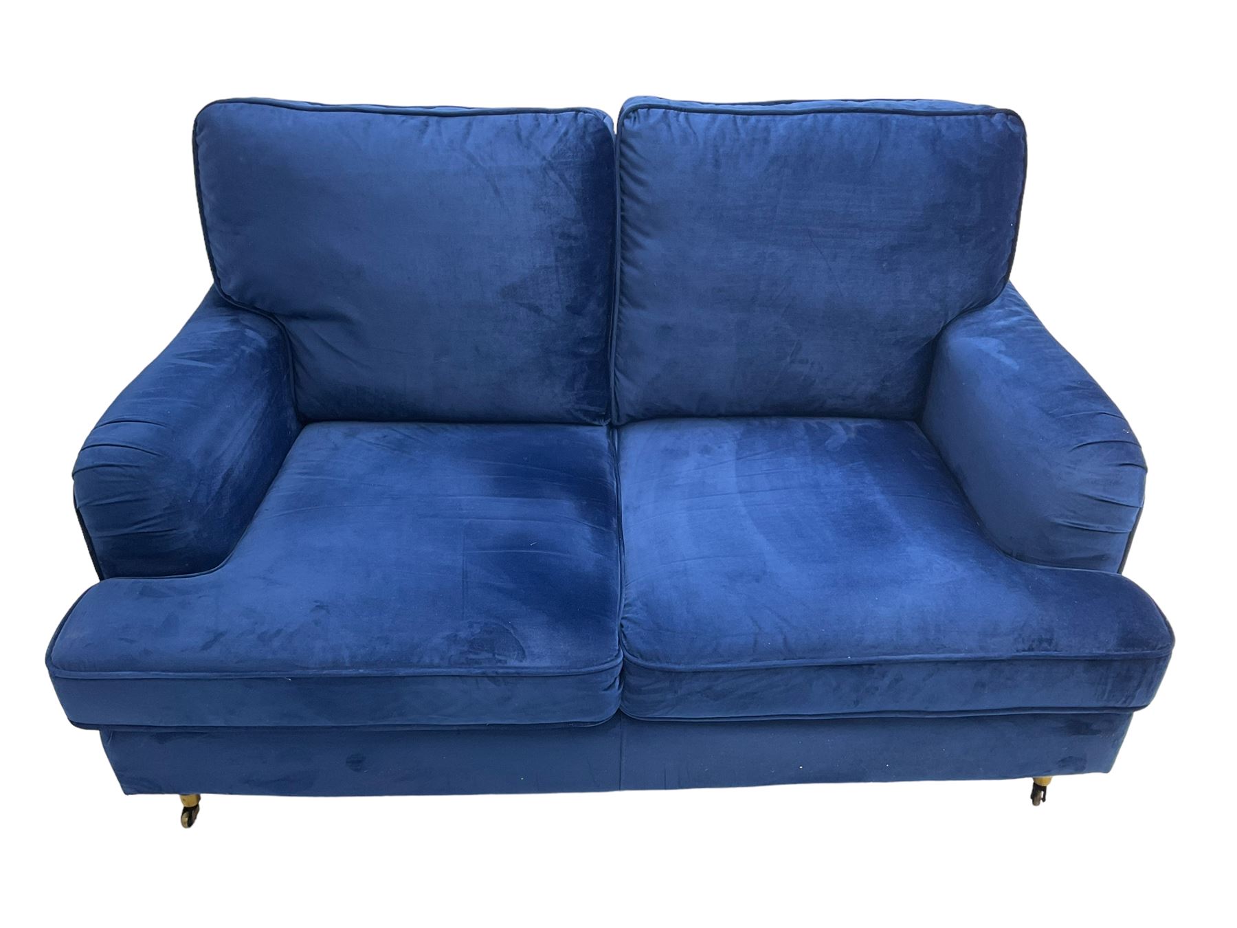 Howard design - two-seat sofa upholstered in blue fabric, traditional shape with rolled arms, on walnut finish turned feet with brushed metal cups and castors