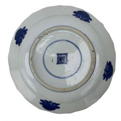 19th century Chinese blue and white saucer dish decorated in the Long Eliza pattern, four character mark within double circle beneath, D13.5cm, and a Chinese shaped dish painted with lotus flowers, provincial shop mark within square border beneath (2)