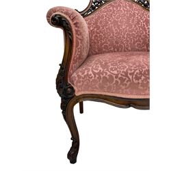 Late 19th century carved walnut framed armchair, the upper spandrels pierced and carved with curled acanthus leaves, upholstered in pink foliate pattern fabric, acanthus leaf carved and scrolled arm facias terminating to cabriole supports, leaf carved terminals 