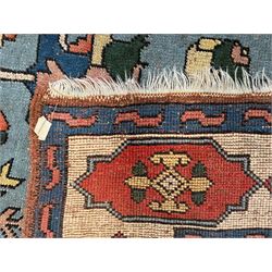 Turkish indigo ground rug, the shaped central field decorated with a central geometric stylised plant motif, enclosed with a guarded border decorated with contrasting motifs 