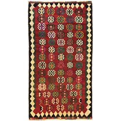 Southwest Persian Qashqai Kilim red ground rug, the central field adorned with rows of multicolored hexagonal medallions with geometric patterns, the border featuring alternating black and white stepped diamonds, narrow band to one end decorated with multicoloured geometric figures