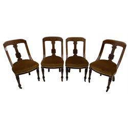 Set of four late Victorian walnut dining chairs, carved with stylised floral decoration and scrolling branches, upholstered seat, on turned and fluted supports 