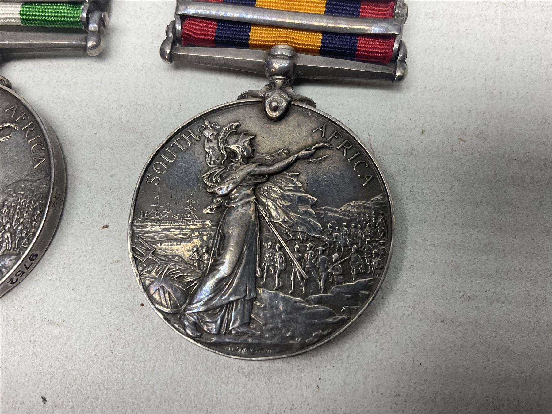 Boer War pair of medals comprising Queens South Africa Medal with two clasps for Paardeberg and Relief of Kimberley and Kings South Africa Medal with two clasps for South Africa 1901 & 1902, awarded to 9752 Dvr. T. Finan A.S.C. with ribbons (2)