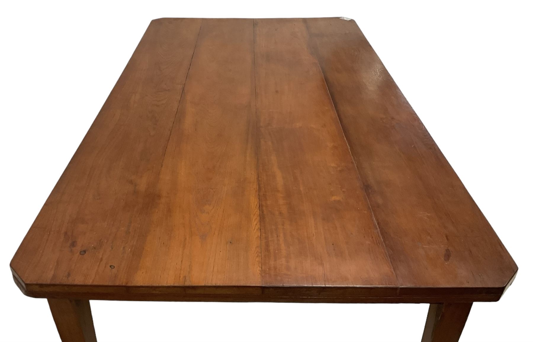 Mid-to-late 20th century teak dining table, rectangular top with canted corners, on square tapering supports with spade feet (214cm x 119cm, H76cm); and a set of eight Burmese reclaimed teak dining chairs, high arched back over panelled seat