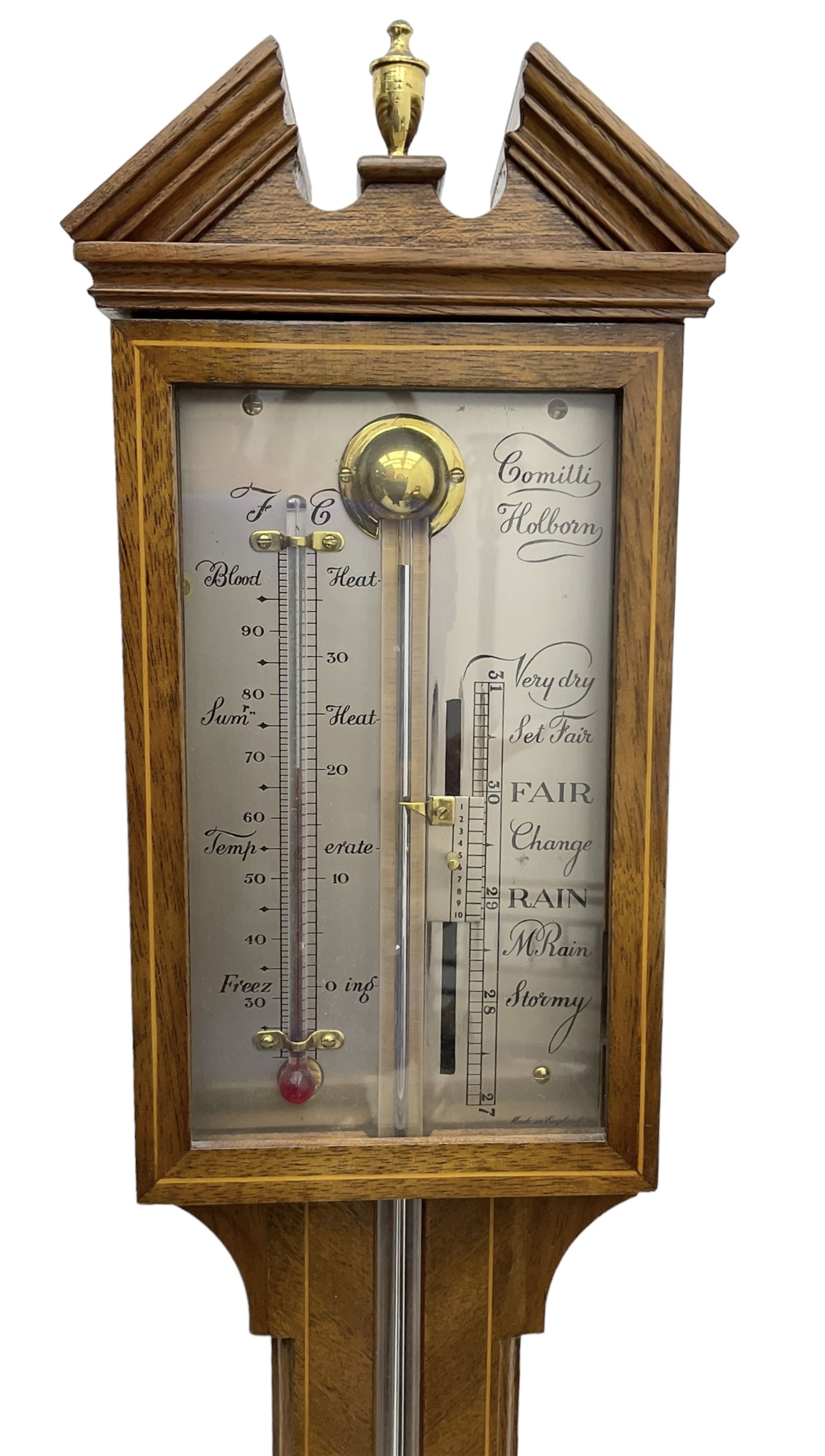 Commiti - 20th century Mercury stick barometer in the 18th century style, with a broken pediment and brass finial, silvered register with a spirit thermometer and vernier gauge within a glazed door, visible cistern tube and circular cover to the base.