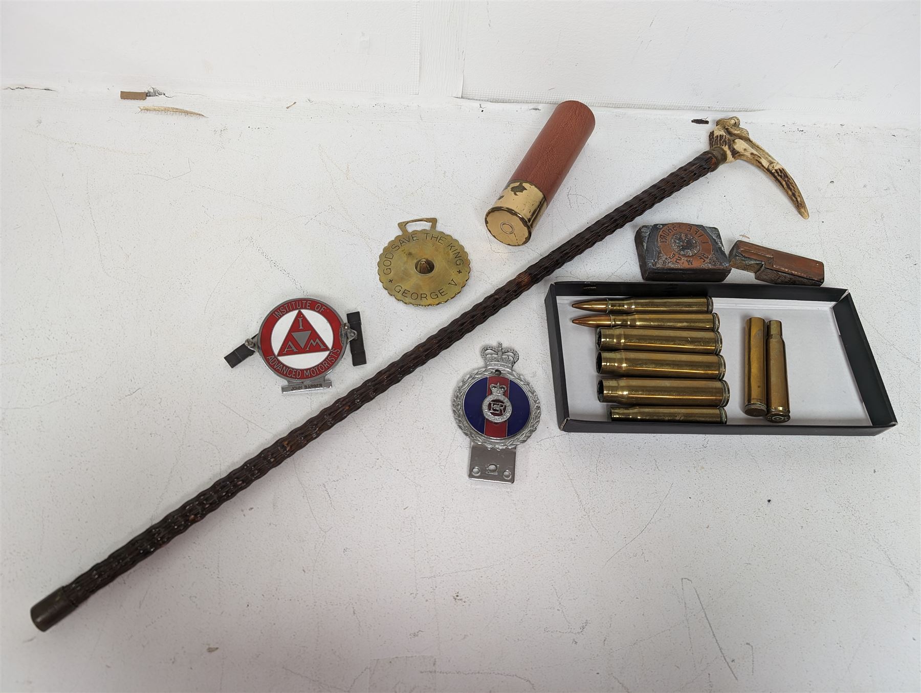 Walking stick with carved monkey handle, glass shooting flask in the form of a cartridge, bullet casings and other collectables