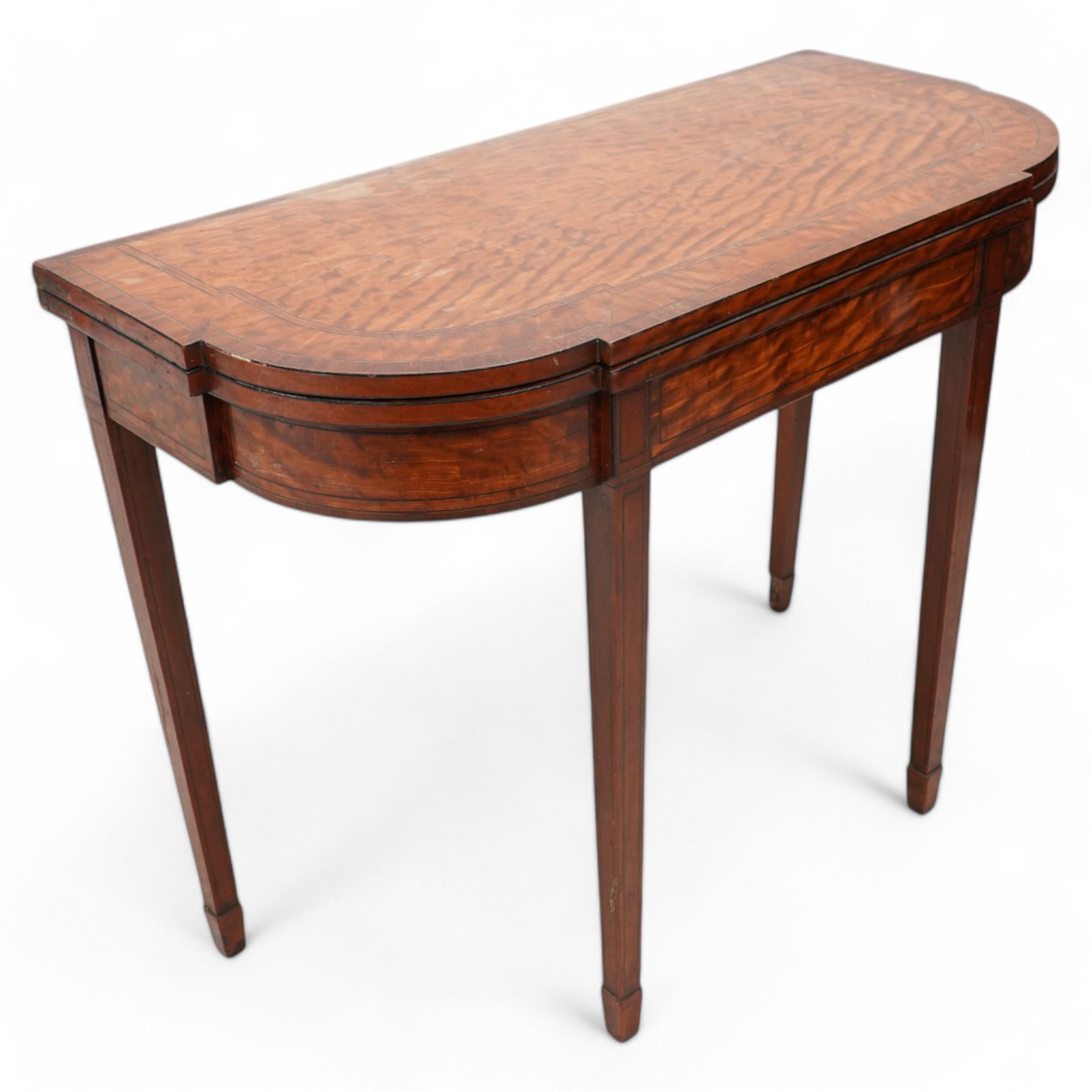 Sheraton period satinwood card table, stepped D-end form, fold-over top revealing baize playing surface, double gate-leg action base, on square tapering supports with peg feet 