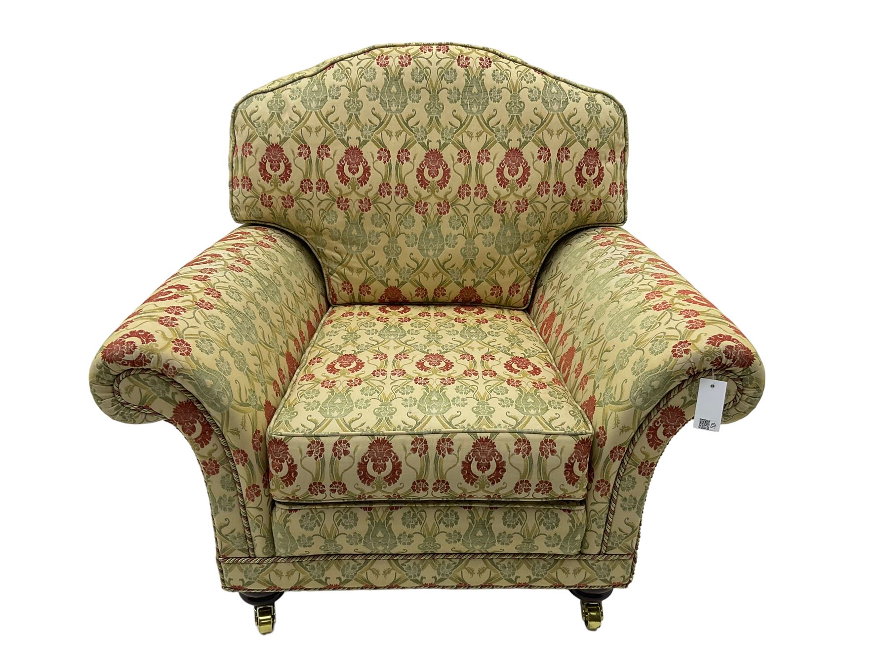 Traditional design two seat sofa, high back with scrolled arms, upholstered in beige fabric with red and green damask motifs, on castor supports (L178cm, D100cm, H89cm); matching armchair (L109cm, D89cm, H89cm)