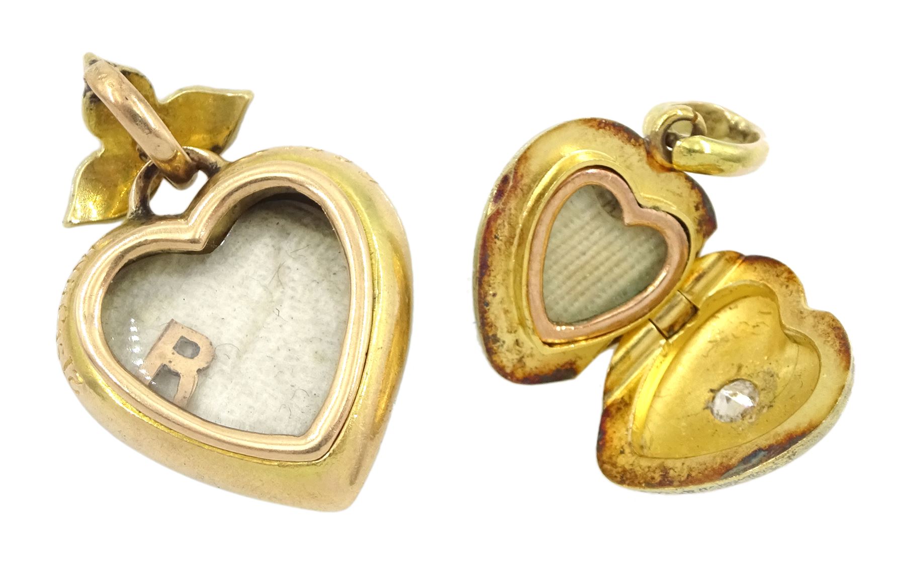 Victorian gold single stone old cut diamond, hinged locket heart pendant, stamped 15 and one other Victorian 15ct gold green enamel heart pendant, with white enamel border, applied gold pearl decoration and split pearl leaf bail, the reverse with glazed locket and engraved 21st June 1899