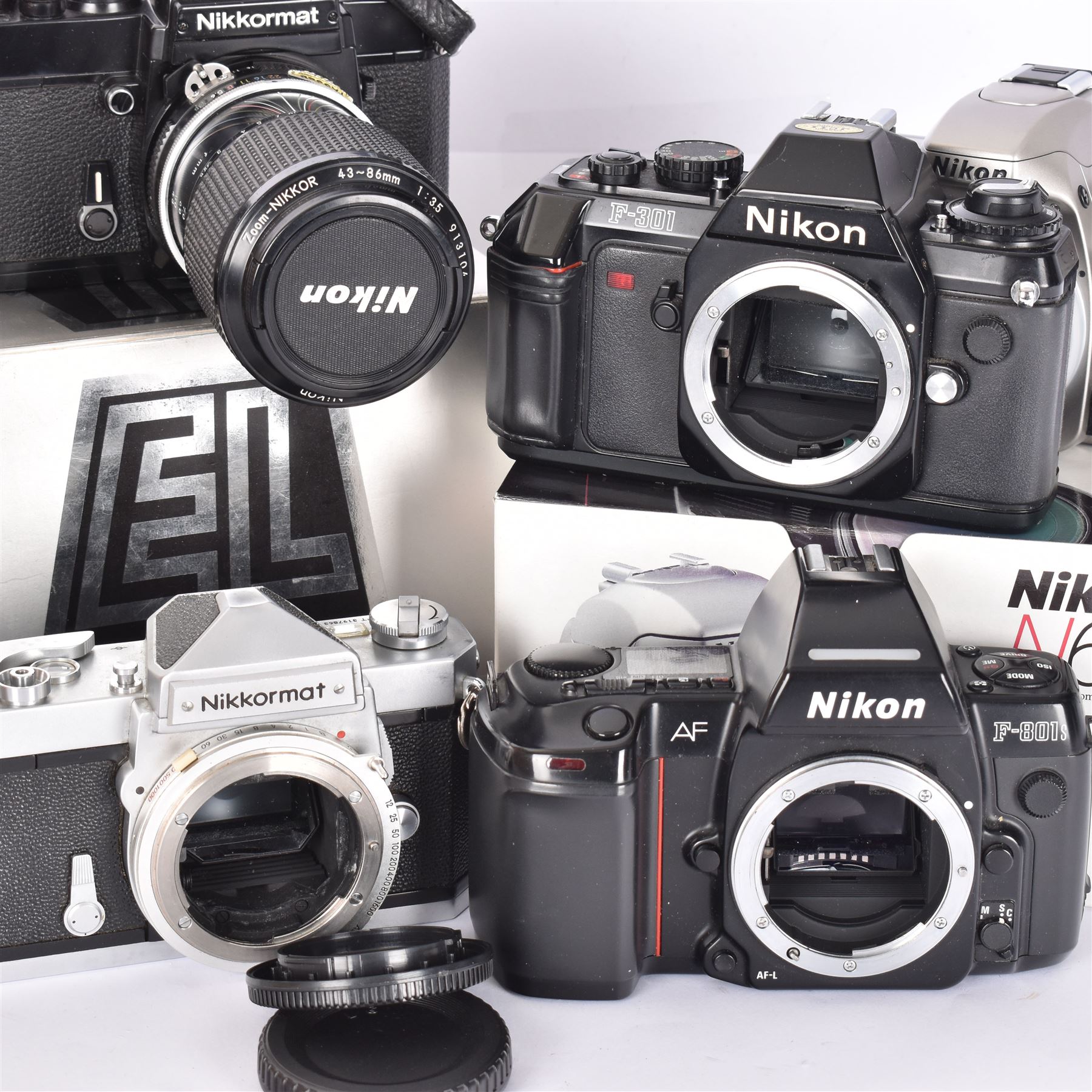 Collection of Nikon cameras, to include N65 serial no. 3103095, boxed, AF F-601 serial no. 2049522, boxed, F-801s serial no. 3330641, F-301 serial no. 3349050 and two Nikkormat cameras, to inlcude an EL example serial no. 5236494, with a nikkor Zoom 43-86mm 1:35 lens serial no. 913104, boxed and one other