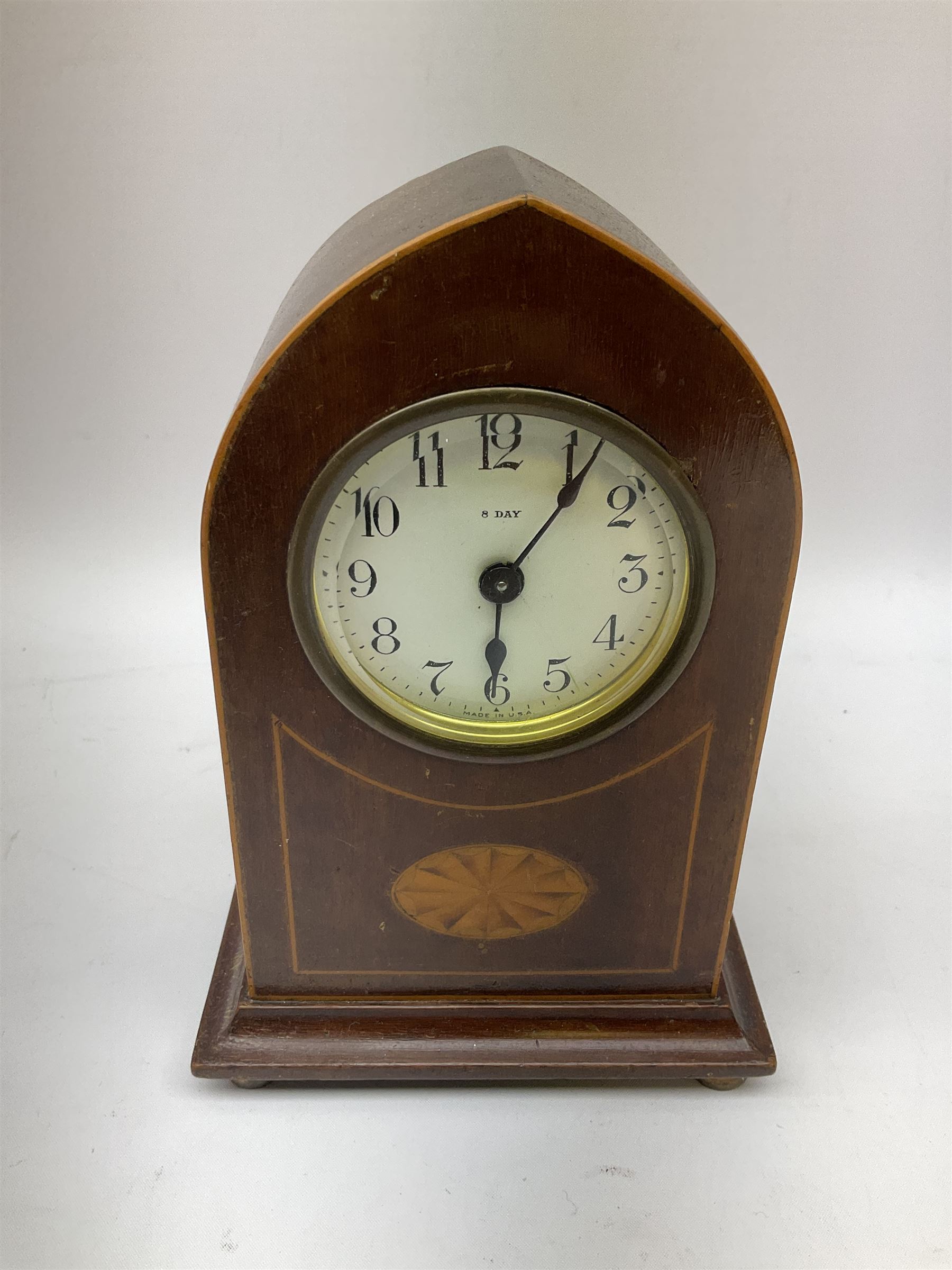 Edwardian mahogany and boxwood strung mantel lancet clock, the dial with black Roman numerals, marked 8 Day Made in U.S.A, upon four compressed bun type feet, H18.5cm