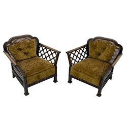 Early 20th century three-piece bergère suite - three seat sofa (W177cm, H82cm, D75cm); pair of matching armchairs (W84cm); single caned back with 'cock-pen' panelled arms, upholstered in foliate pattern fabric, blind fretwork lower frieze over square feet 