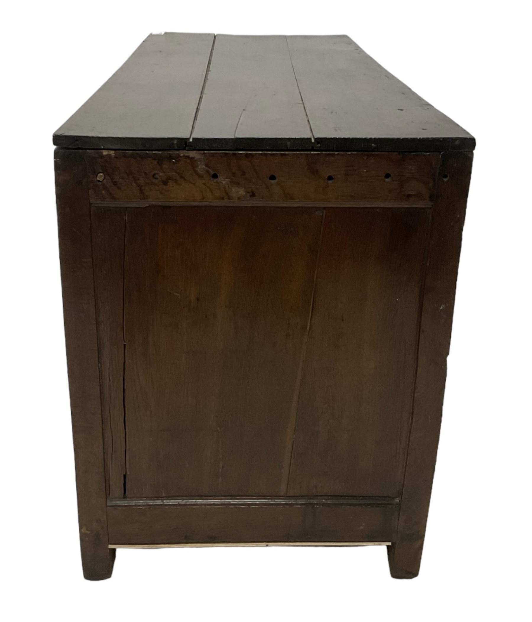 Large 18th century oak coffer or blanket box, hinged lid over triple panelled front, panelled back and sides, on stile supports 