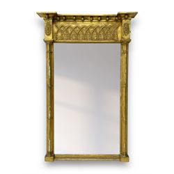 Regency giltwood and gesso pier mirror, projecting cavetto cornice with ball mounts, the frieze decorated with pointed arcade and foliate motifs, plain mirror plate enclosed by cluster column pilasters 