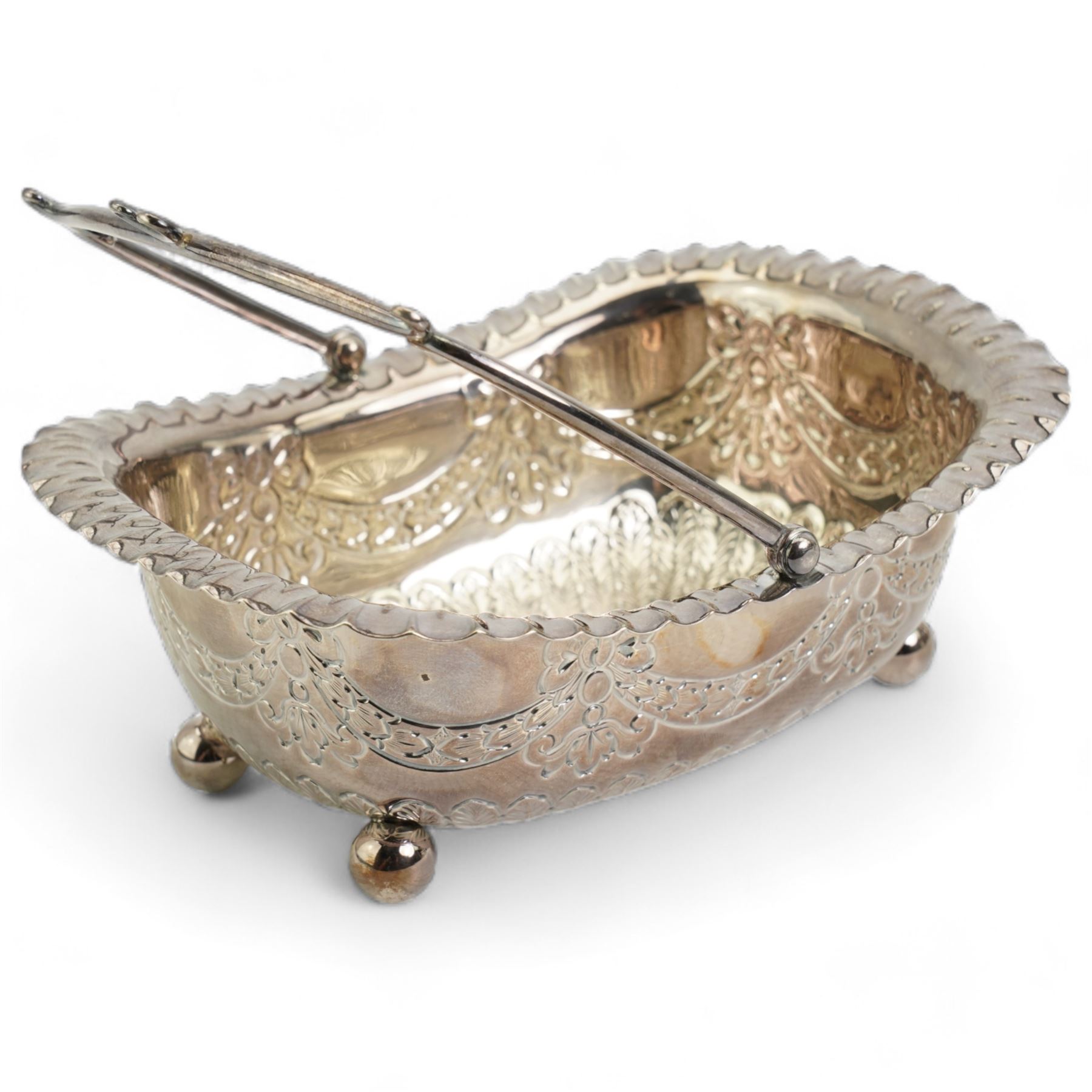  Victorian silver rectangular sugar basket with swing handle decorated with garlands and foliage on ball feet W15cm Sheffield 1891 Maker James Dixon & Son and a silver cream jug and sugar bowl Chester 1919 