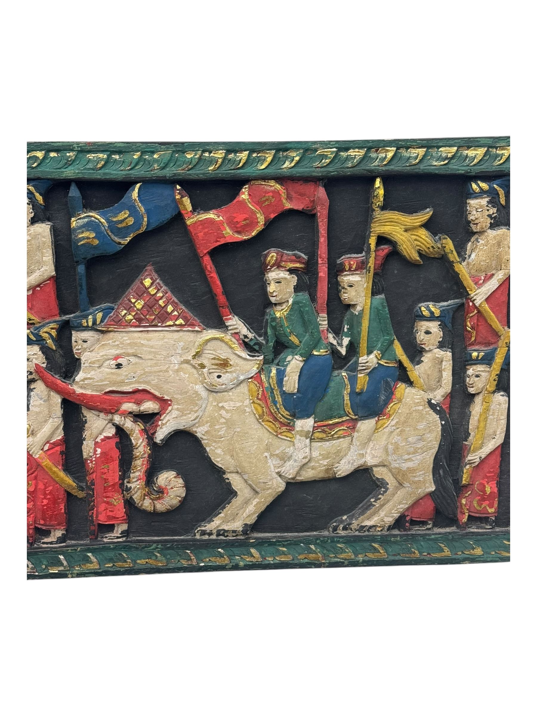 Rectangular relief carved and painted wall hanging panel, depicting ceremonial procession with soldiers and flag bearers on horses and elephants