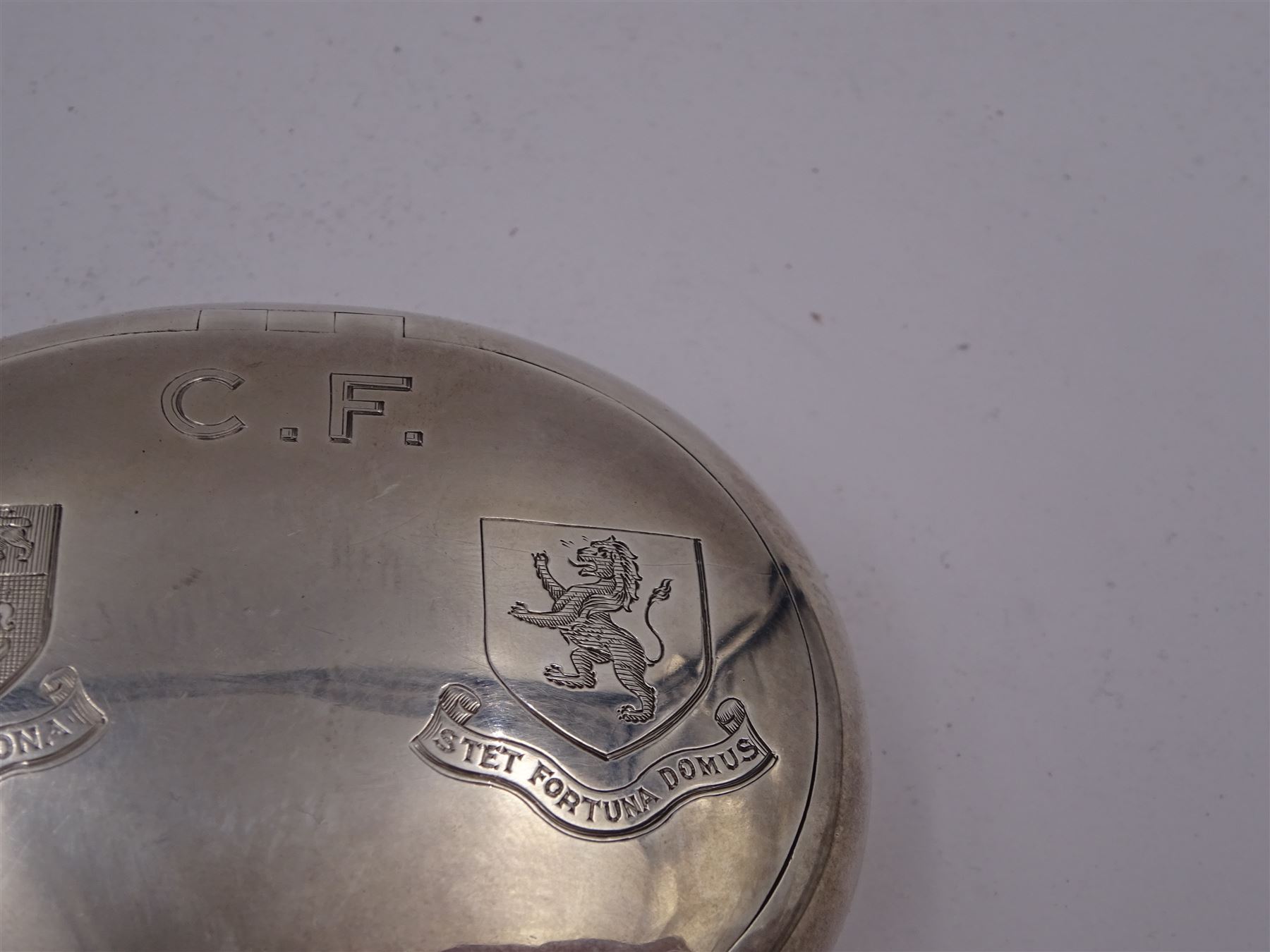 Early 20th century silver squeeze action snuff box, of oval form, engraved verso C.F. Rockcliffe, Darlington, the hinged lid engraved with initials CF and the crests for both Harrow School and Eton College, opening to reveal a gilt interior, hallmarked George Unite, Birmingham 1919, L8cm