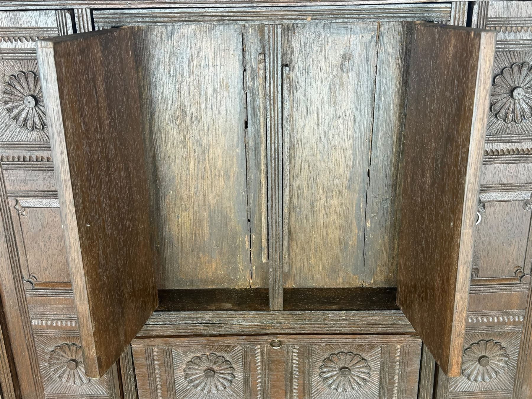 20th century mahogany chest, rectangular hinged top enclosing removable compartments with carved starburst motifs with linear and geometric patterns, brass inlay to the top and front, mounted corners and edges, on bracket base