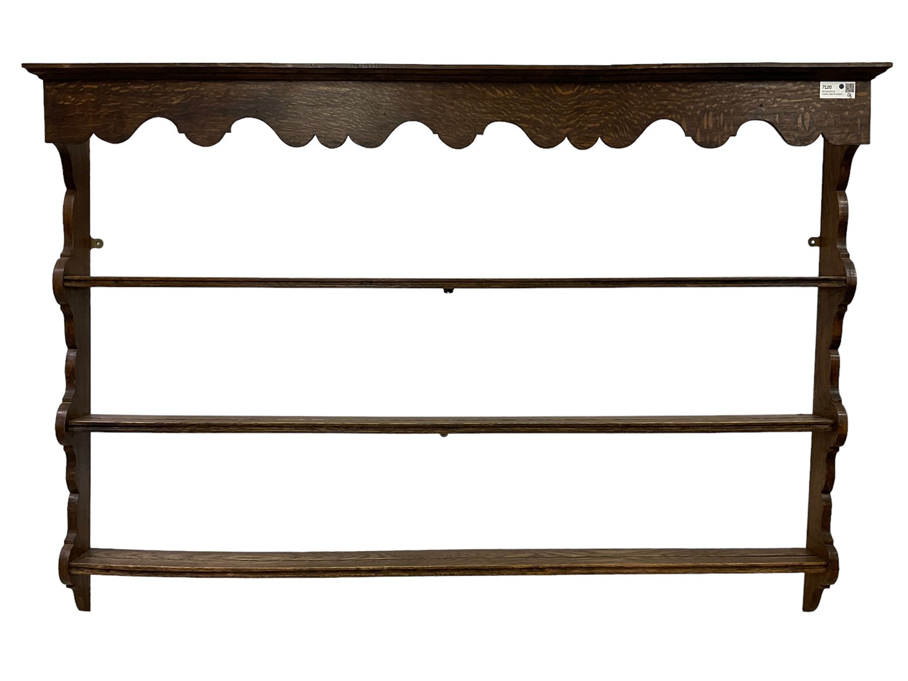 Early 20th century oak wall hanging Delph rack, applied moulded cornice over shaped frieze, three-tiers supports by shaped end supports