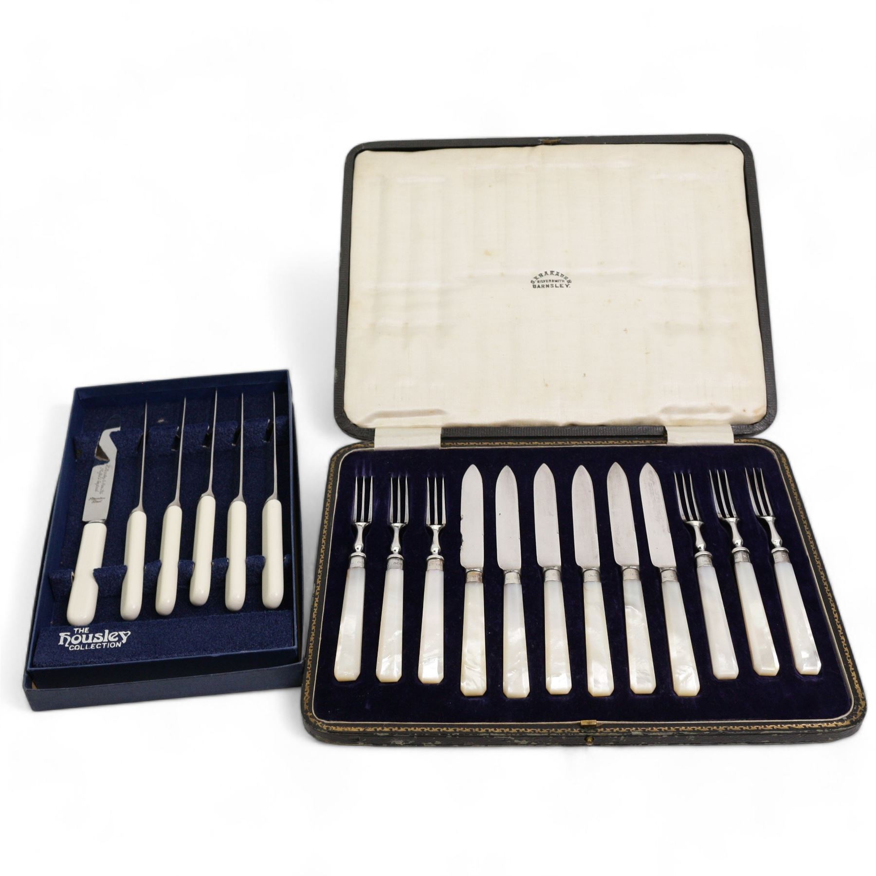 Early 20th century cased set of six fruit knives and forks, with mother of pearl handles and silver collars, by John Sanderson & Son Ltd, Sheffield, 1921, together with a set of six knives (2)