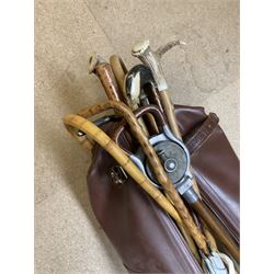 Group of assorted walking sticks, to include bamboo examples, examples with horn/antler handles, contained within a leather bag, plus two further leather bags 