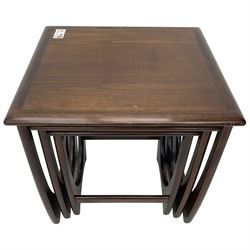 Mid 20th century teak nest of three tables, square tops with rounded edges, on curved supports with stretchers