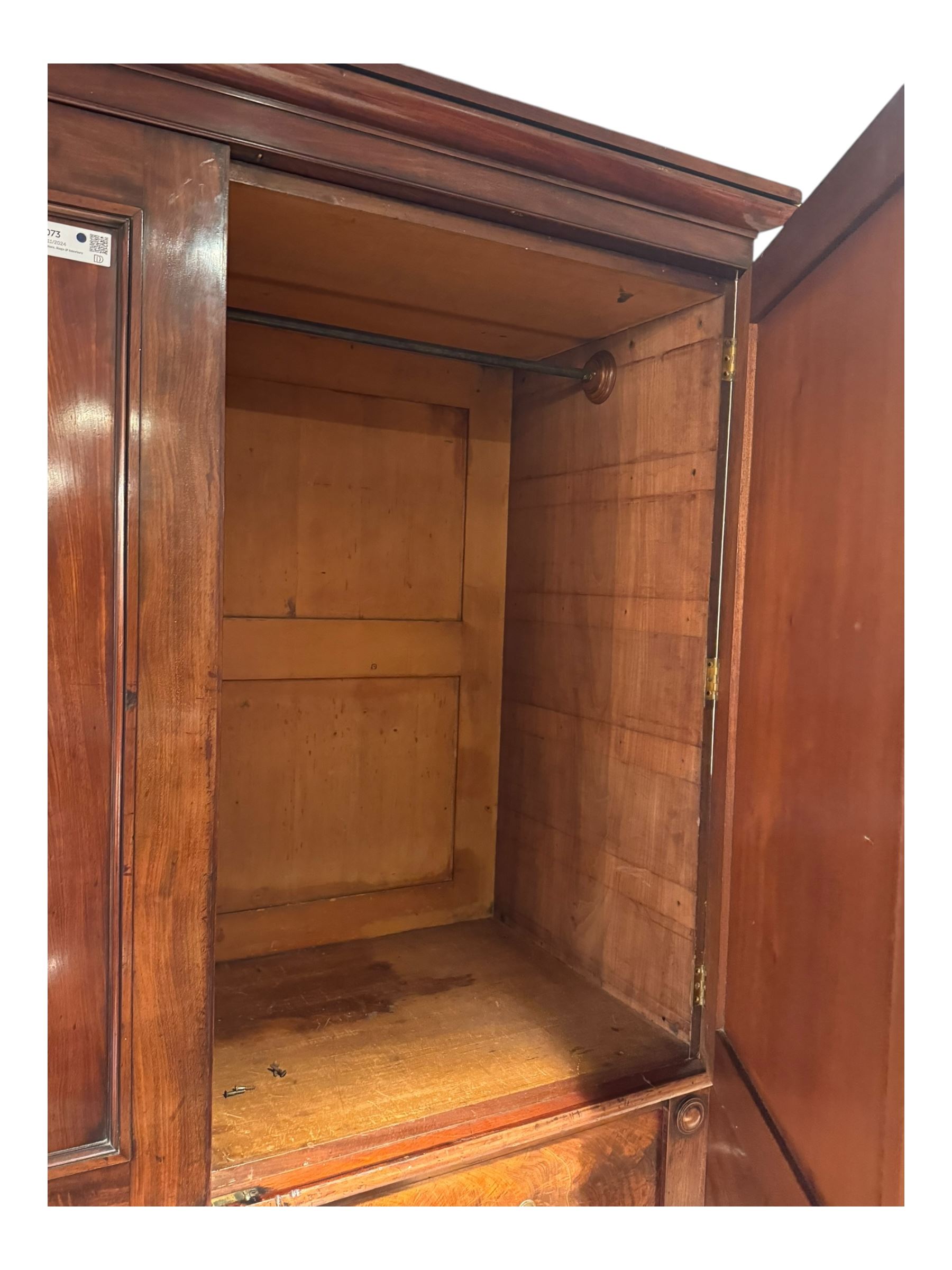 Victorian mahogany linen-press, moulded cornice over two figured panelled doors, the interior fitted with five slides and hanging rail, four long drawers below 