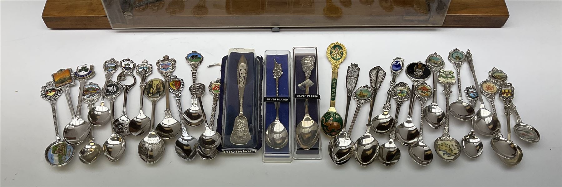 Collection of souvenir teaspoons with wooden display case, H62cm, L53cm. 