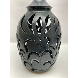 John Egerton (c1945-): studio pottery stoneware lamp base, decorated with pierced floral decoration with a dark blue ground, H56cm 