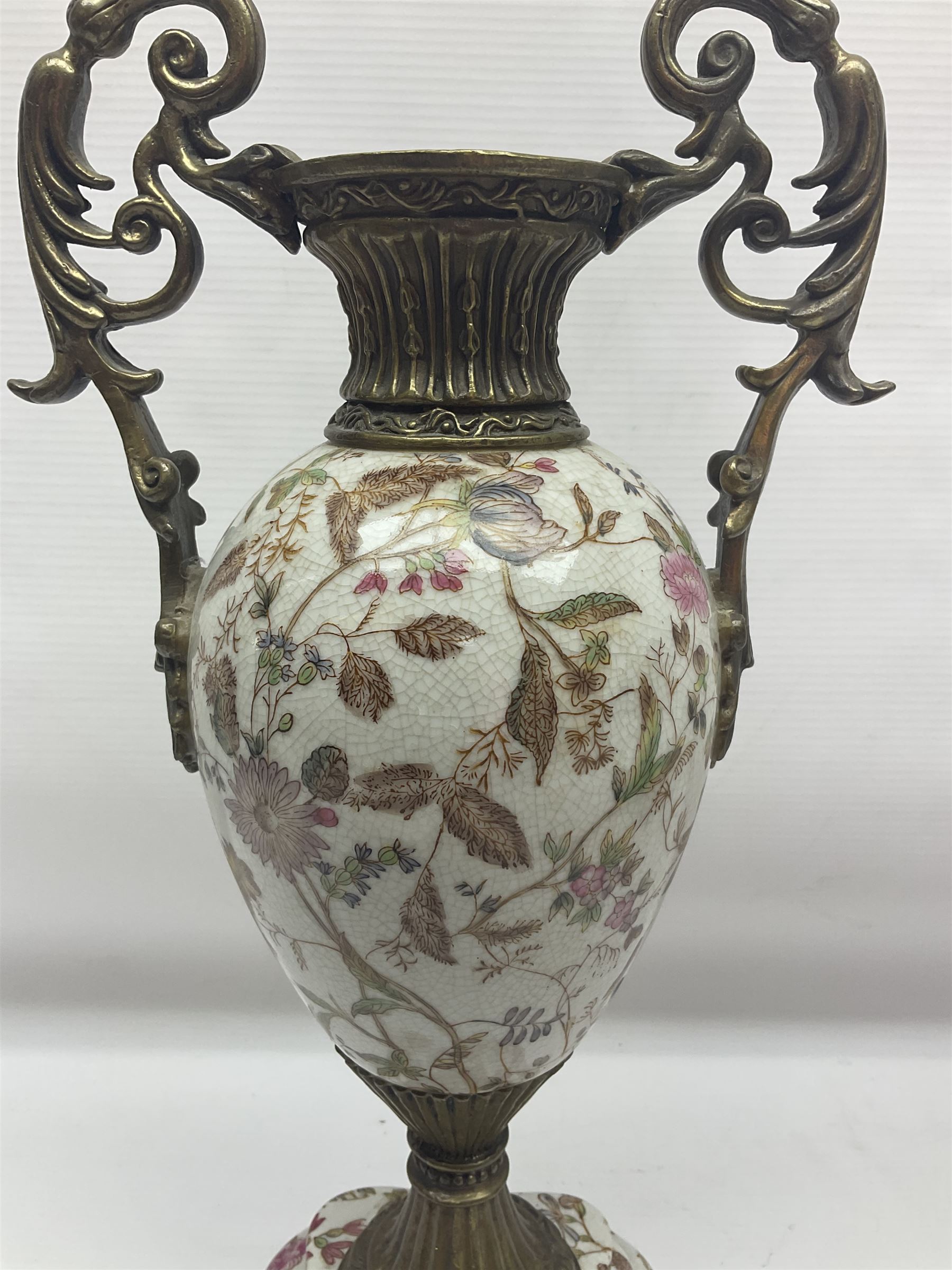 Wong Lee, twin handled ceramic urn with enamelled floral decoration and bronzed metal mounts, upon a square base, marked to base, together with similar twin handled urn with enamelled Cherub decoration, largest H44cm