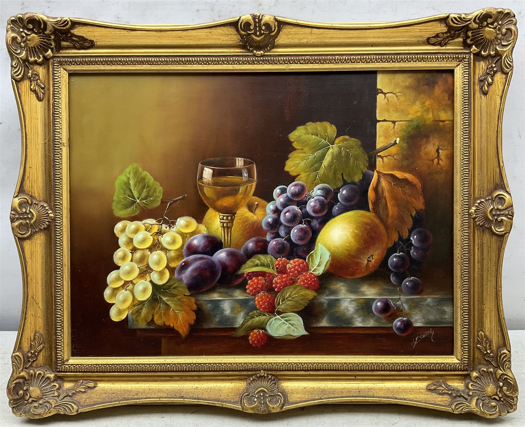 John F Smith (British 1934-): Fruit and Wine Glass, oil on board signed 29cm x 40cm 
Notes: Smith was employed by Royal Worcester as a fruit painter between 1950 and 1971.